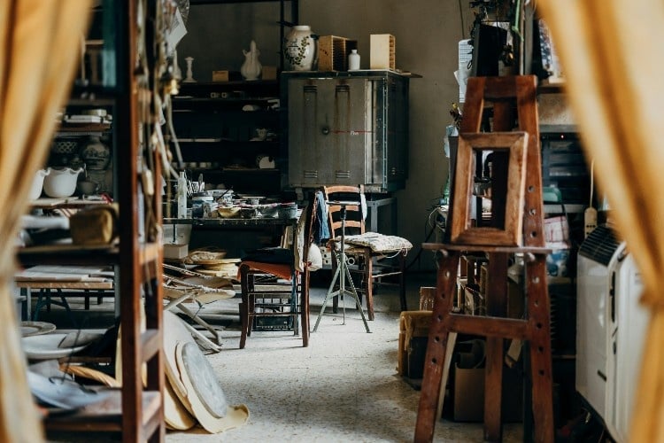 an art studio with an easel and art supplies
