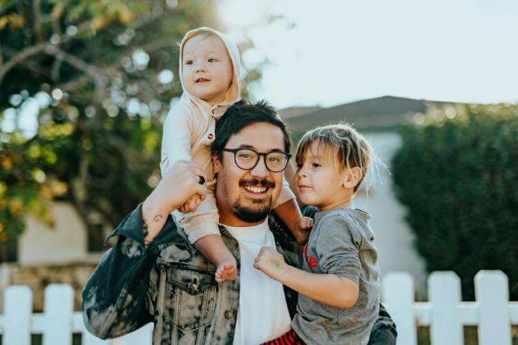 Dad with kids outside in yard