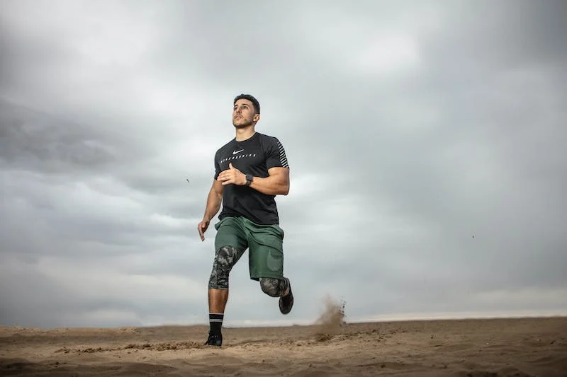 guy running outdoors in fitness gear