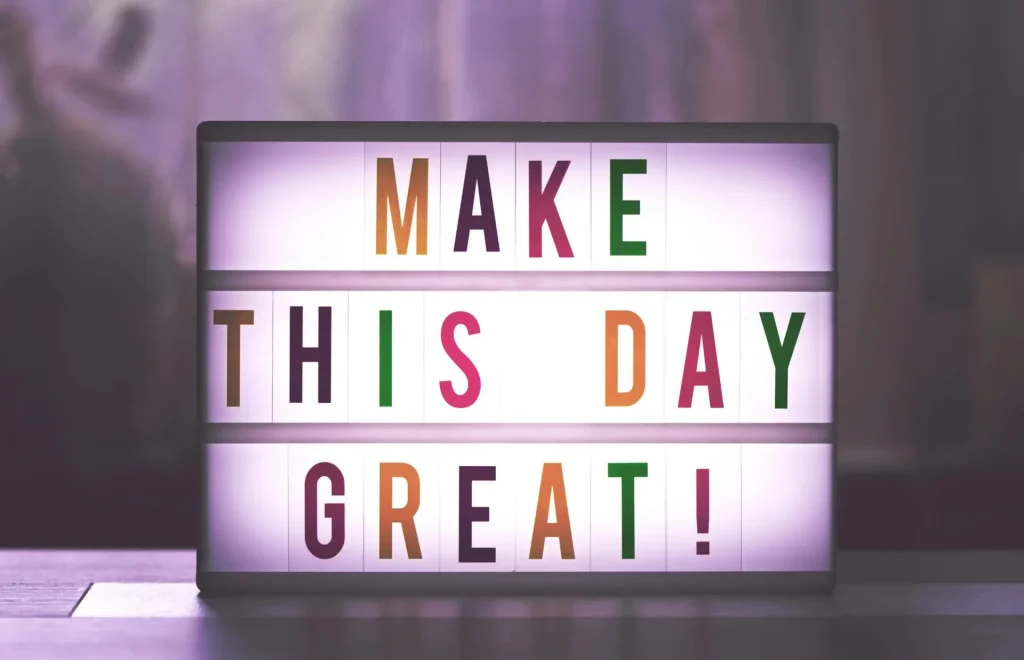 A neon sign that says make this day great!